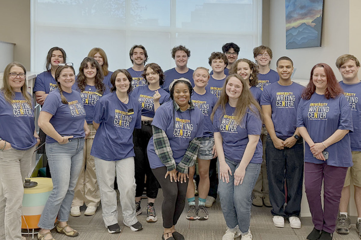 University Writing Center staff gathered in front of a window - Fall 2025.