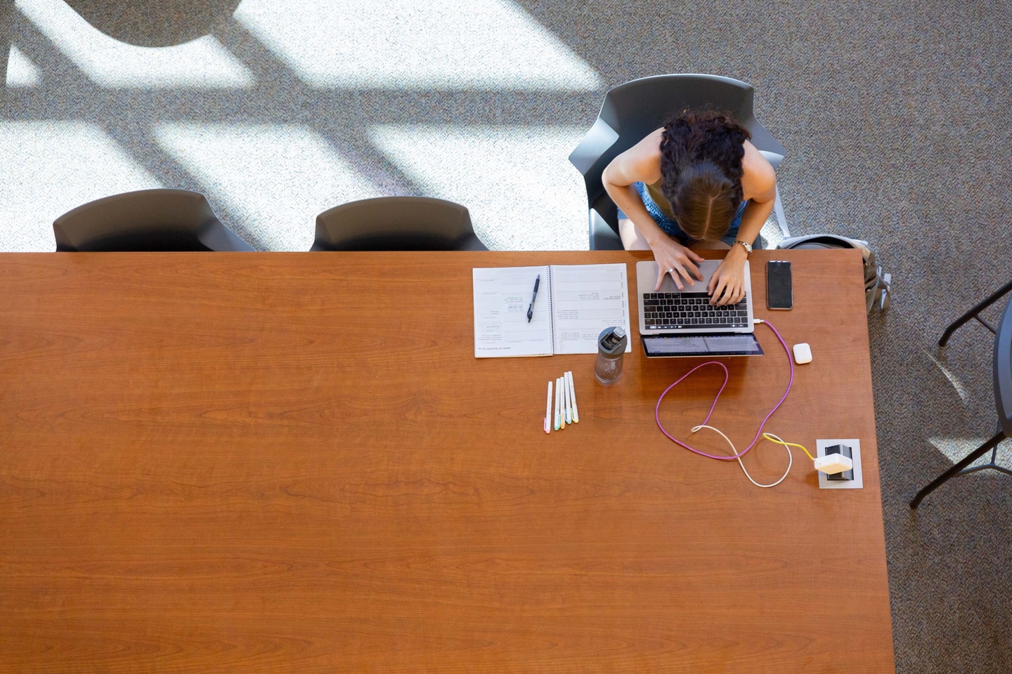Arial view of student at table with laptop